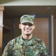 Shot of a young soldier standing in the dorms of a military academy.